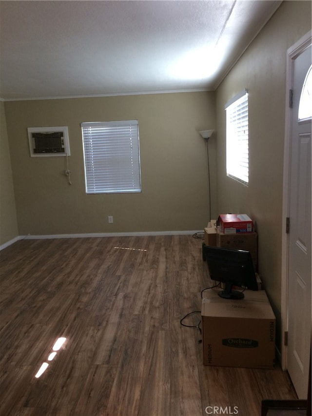 foyer entrance featuring ornamental molding and dark wood-type flooring