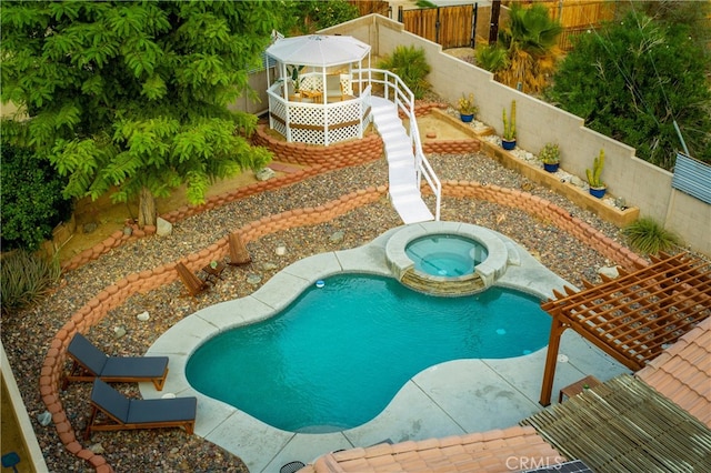 view of pool with a patio and an in ground hot tub