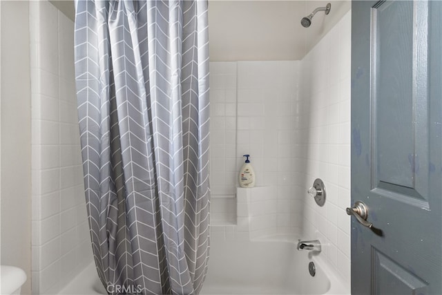 bathroom with shower / tub combo with curtain and toilet