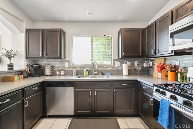 kitchen featuring dark brown cabinets, stainless steel appliances, sink, and tasteful backsplash