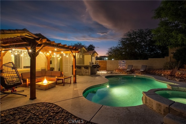 pool at dusk with a pergola, an in ground hot tub, an outdoor living space with a fire pit, and a patio area