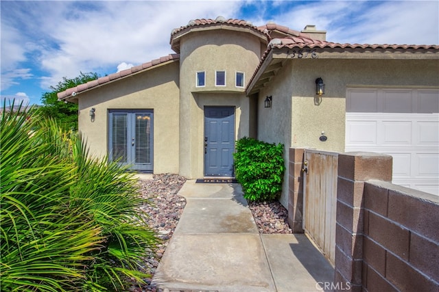 view of exterior entry with a garage