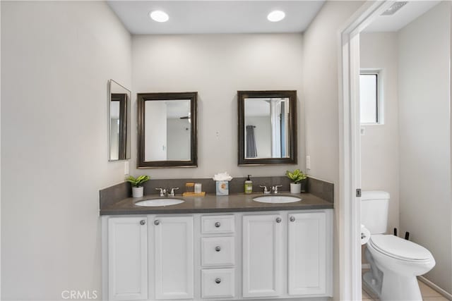 bathroom featuring vanity and toilet