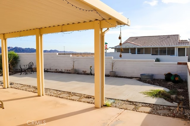 view of patio / terrace featuring a mountain view