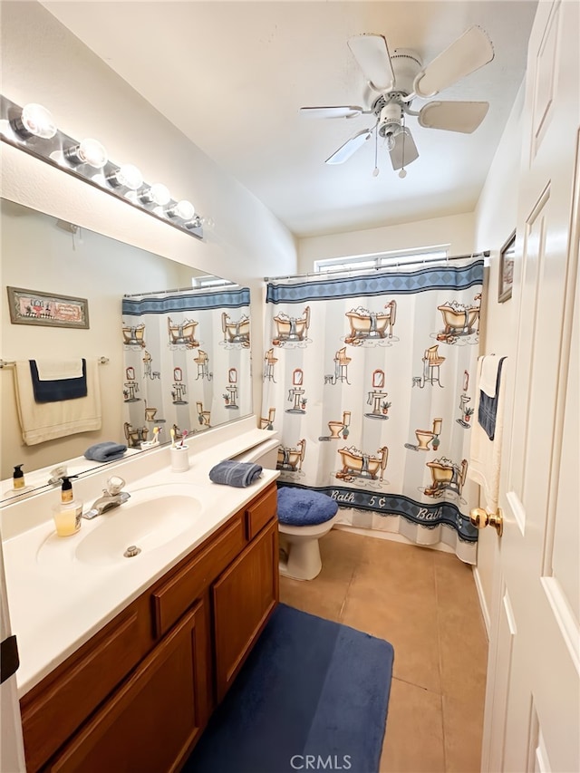 bathroom featuring ceiling fan, vanity, toilet, tile patterned flooring, and a shower with shower curtain