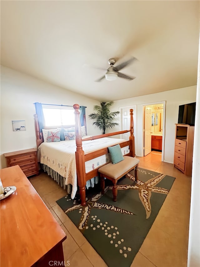 tiled bedroom with ceiling fan and ensuite bathroom