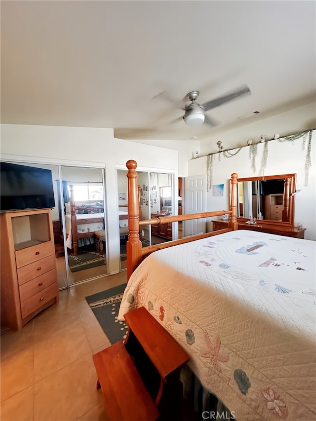 bedroom with ceiling fan and tile patterned flooring