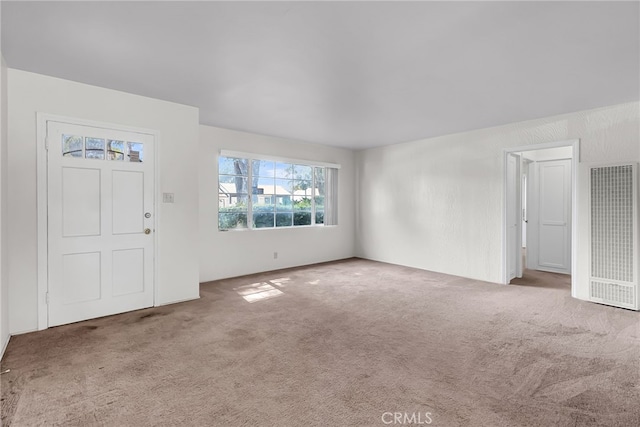 foyer entrance with carpet