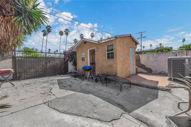 back of house with central AC unit and a patio area