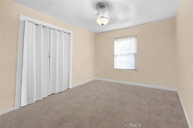 unfurnished room featuring light carpet