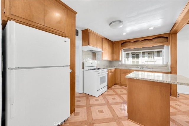 kitchen with sink, light stone counters, backsplash, light parquet floors, and white appliances