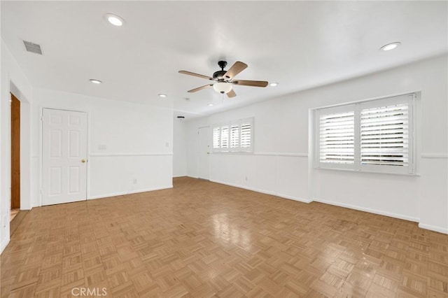 empty room with light parquet floors and ceiling fan