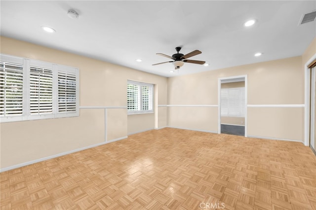 spare room with light parquet floors and ceiling fan