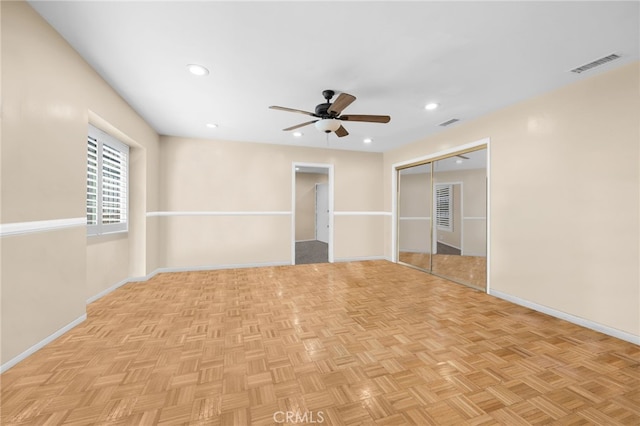 spare room featuring ceiling fan and light parquet flooring