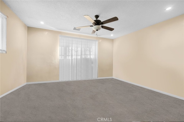 empty room with a textured ceiling, carpet floors, and ceiling fan