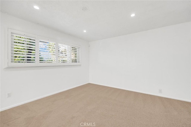 unfurnished room with carpet flooring