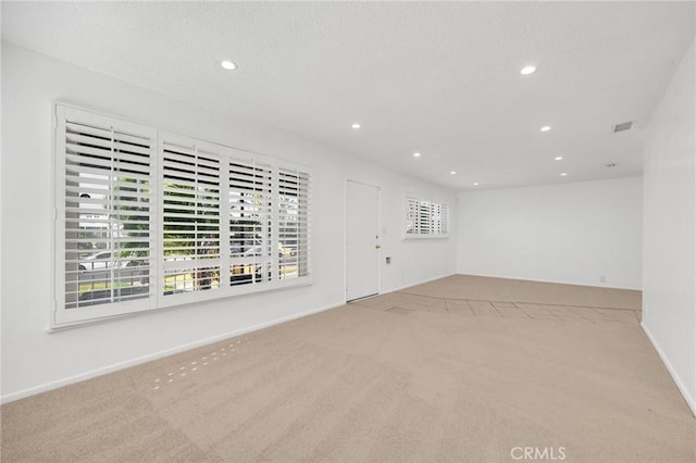 empty room with light colored carpet