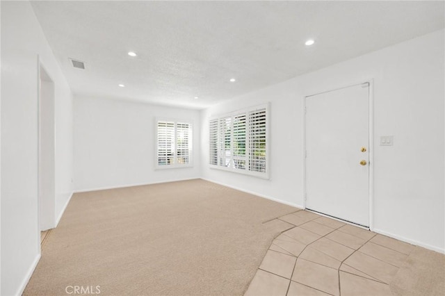 unfurnished room with light colored carpet