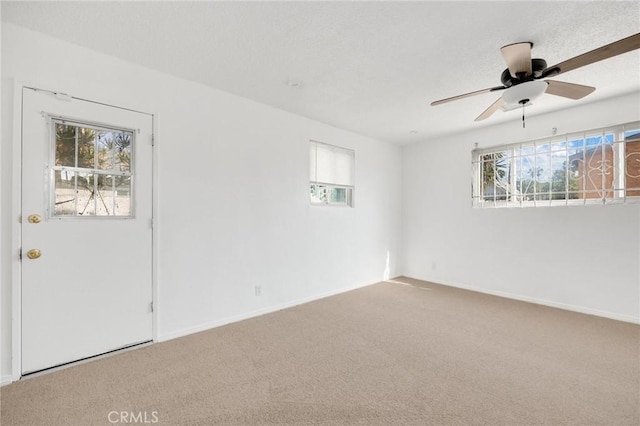 empty room with carpet flooring and ceiling fan