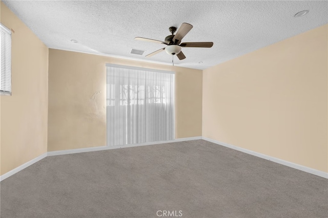 spare room with ceiling fan, carpet, and a textured ceiling