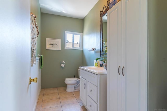 bathroom with tile patterned flooring, vanity, and toilet