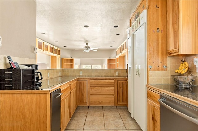 kitchen with tile countertops, backsplash, light tile patterned floors, and kitchen peninsula