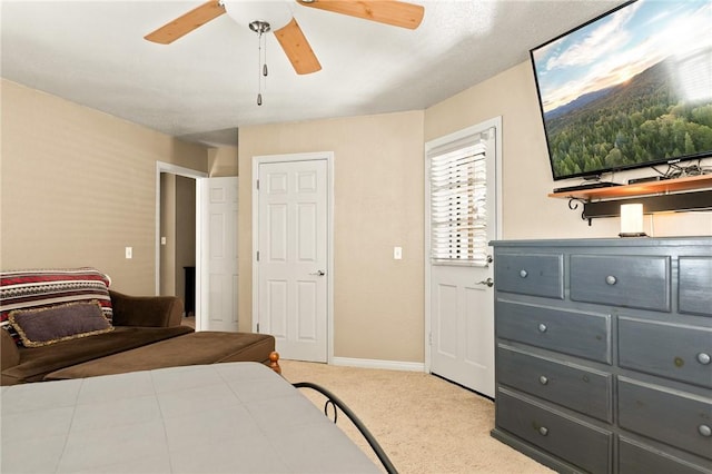 bedroom featuring light colored carpet and ceiling fan