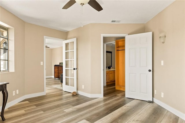 interior space with wood-type flooring and ceiling fan