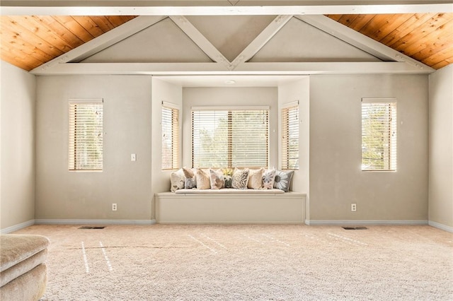 spare room featuring carpet and vaulted ceiling with beams