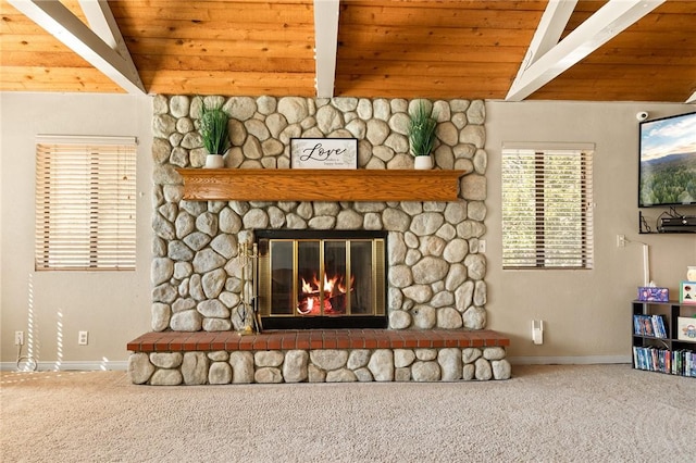 details with beam ceiling, wood ceiling, a stone fireplace, and carpet flooring