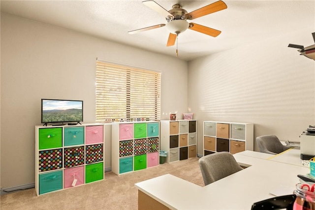 home office featuring ceiling fan and light carpet