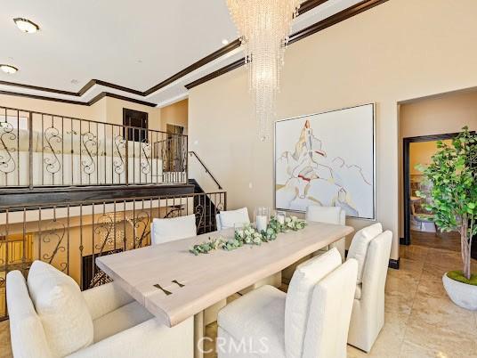 dining space with a chandelier and ornamental molding