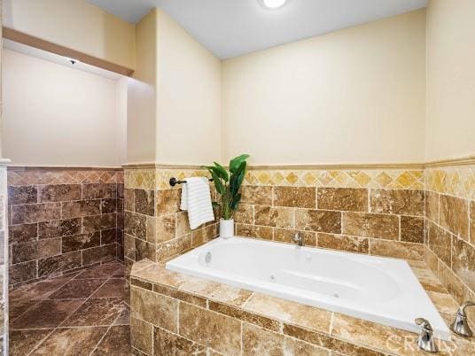 bathroom featuring a relaxing tiled tub