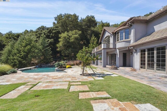 view of swimming pool with a lawn and a patio