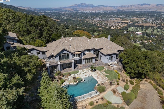 birds eye view of property featuring a mountain view