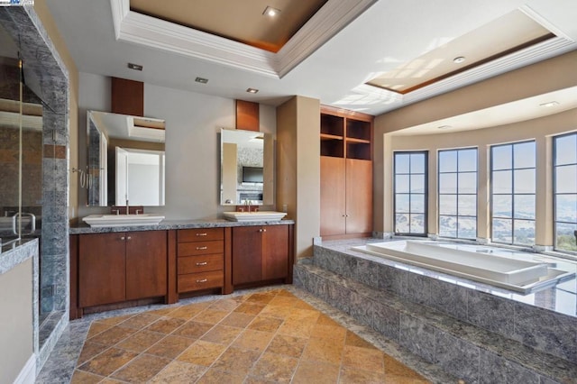 bathroom featuring a tray ceiling, separate shower and tub, crown molding, and vanity