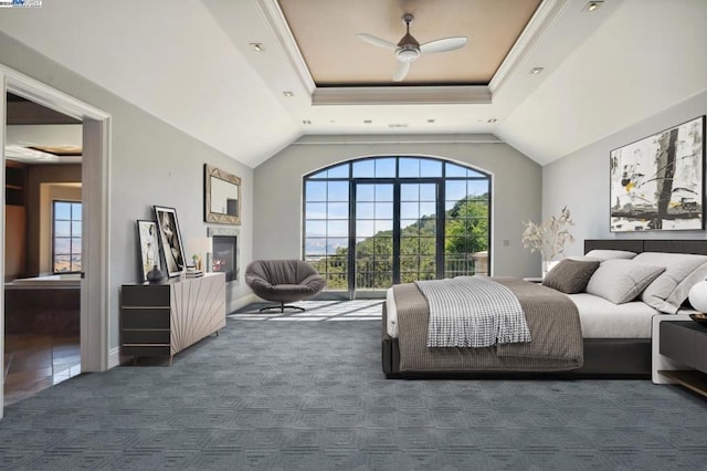 carpeted bedroom featuring a raised ceiling, vaulted ceiling, ceiling fan, and crown molding