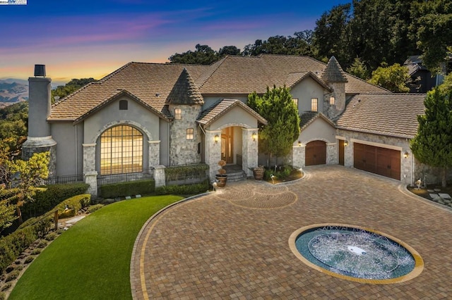 french provincial home featuring a garage