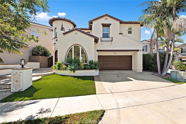 mediterranean / spanish home with a garage