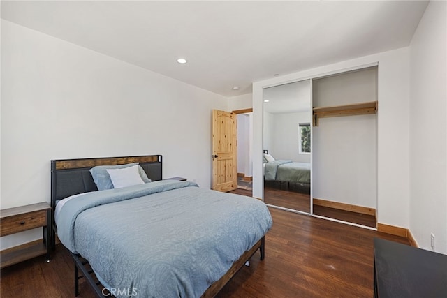 bedroom featuring a closet and dark hardwood / wood-style floors