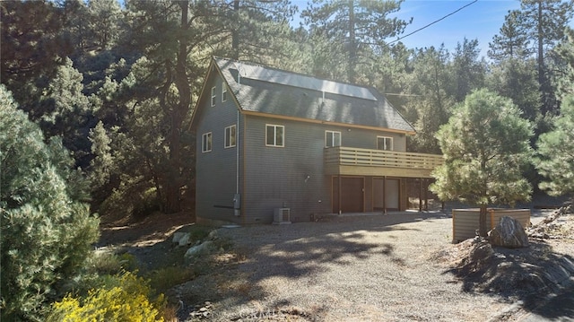 rear view of house featuring a balcony and central air condition unit