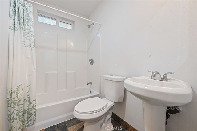 bathroom featuring shower / bathtub combination with curtain, lofted ceiling, and toilet