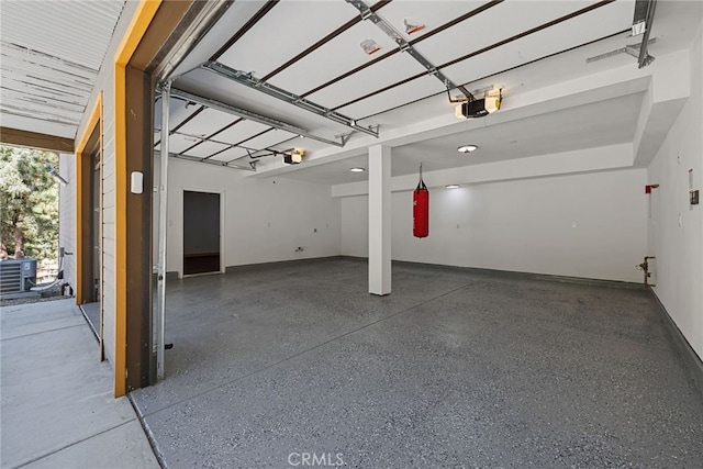 garage featuring a garage door opener and central air condition unit