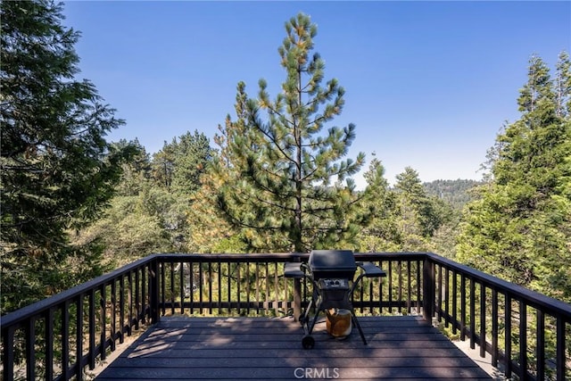 wooden terrace featuring a grill