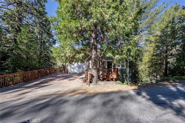 view of front facade featuring a wooden deck and a garage