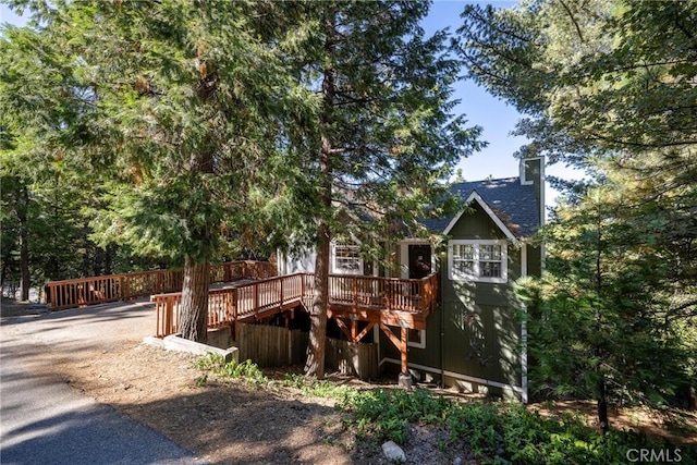 rear view of house featuring a wooden deck