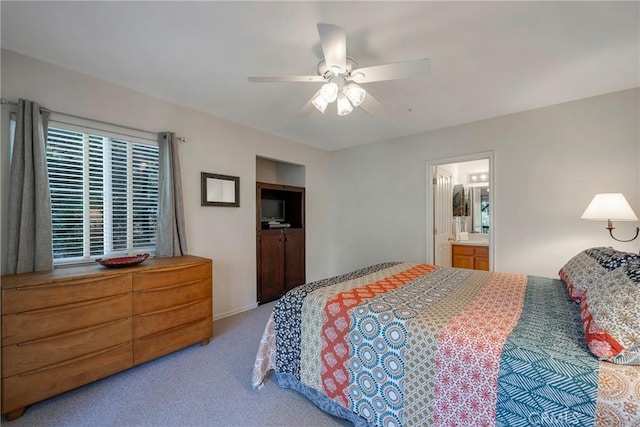 bedroom featuring ceiling fan, light carpet, and connected bathroom