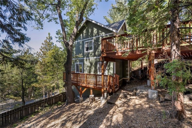 rear view of property featuring a deck