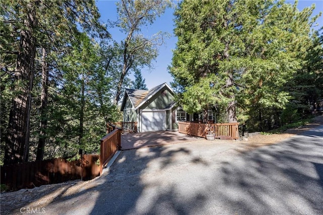 view of side of home with a garage and a deck