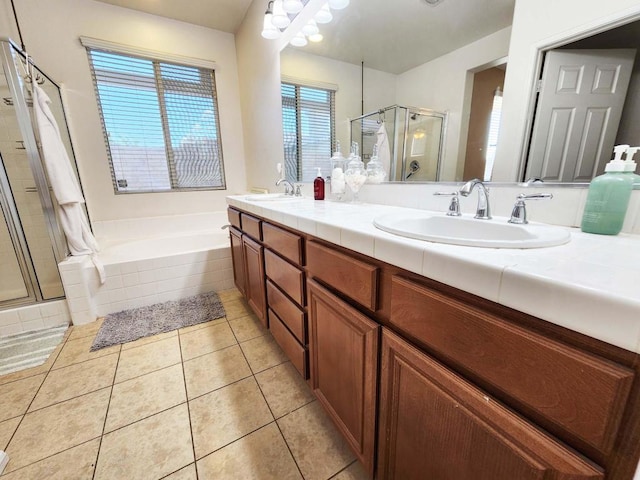 bathroom with independent shower and bath, vanity, and tile patterned floors